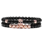 Double bracelet en perle d'onyx noir tête de mort or rose